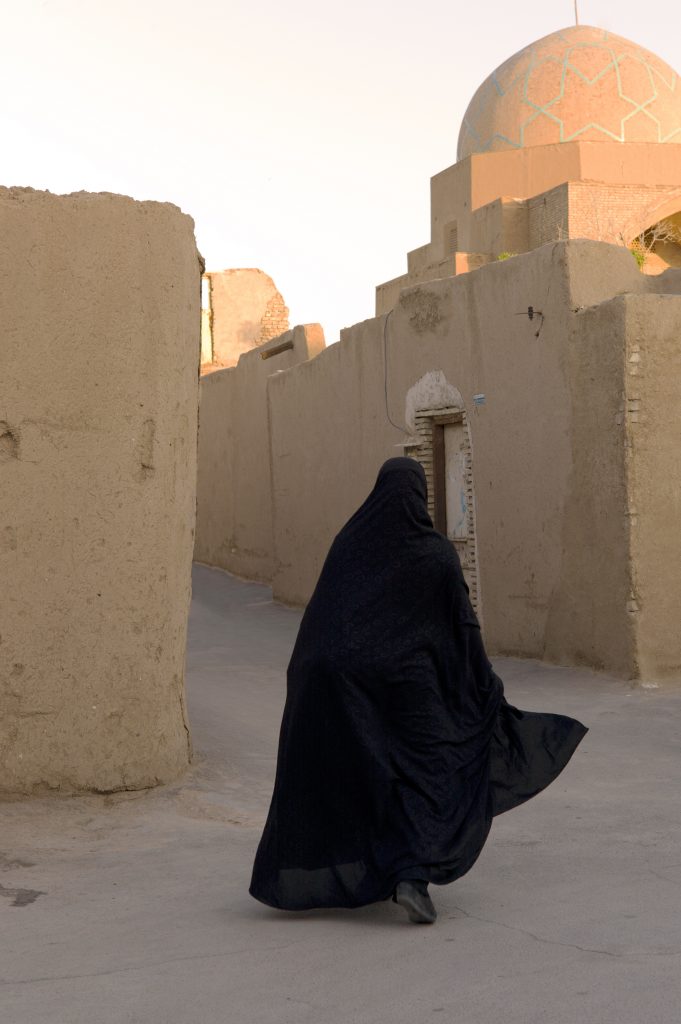 Burqa woman in a village of adobe