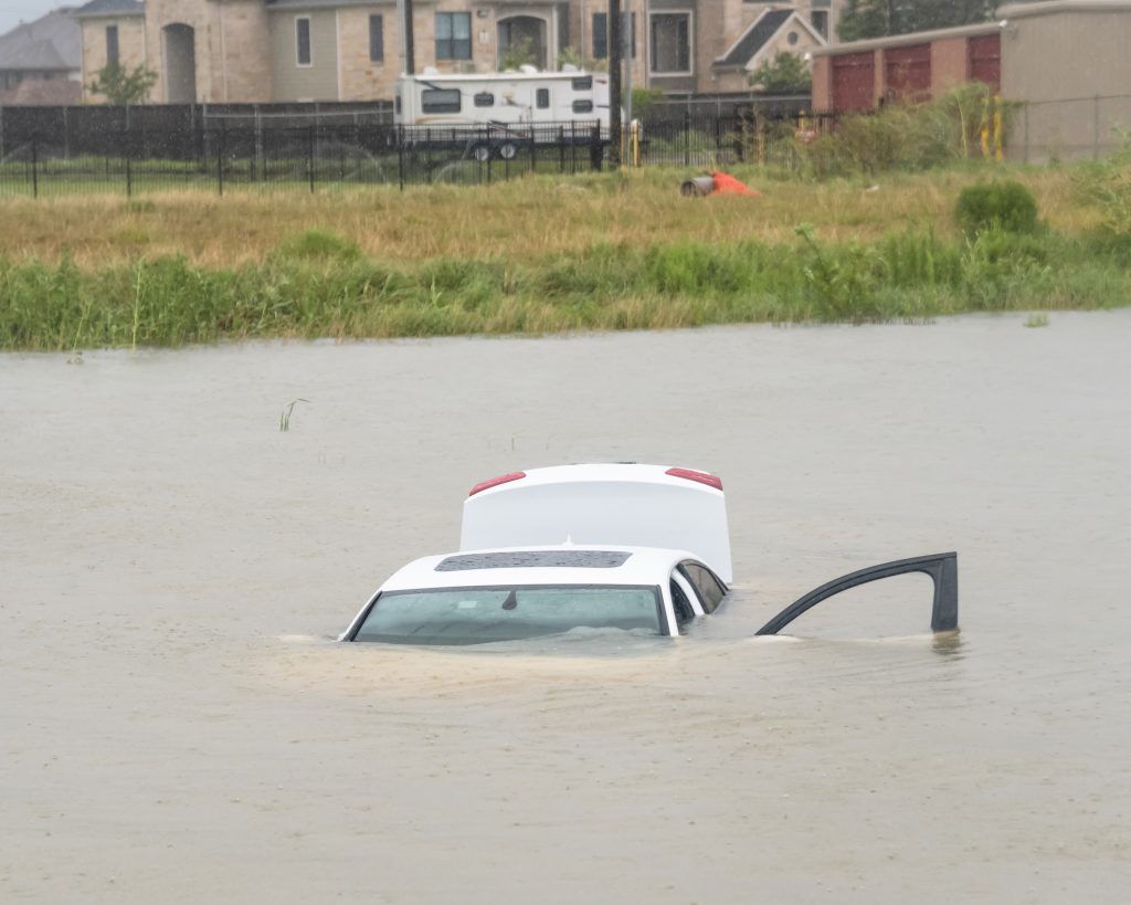 Sedan car swamped by flood water in Humble, Texas, US by Harvey Tropical Storm. Flooded car under deep water flood road. hurricane harvey Disaster Severe weather c